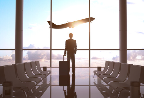 businessman traveller in airport watching plane